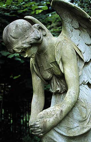 kneeling angel, head bowed.