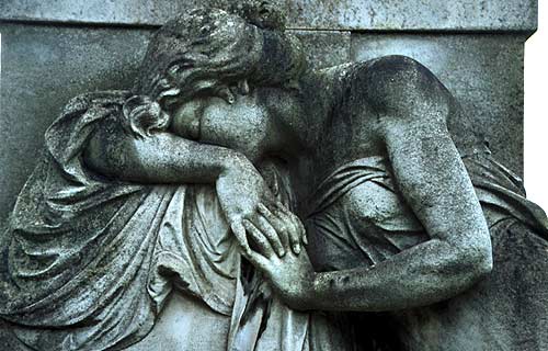 greiving woman, hands clasped